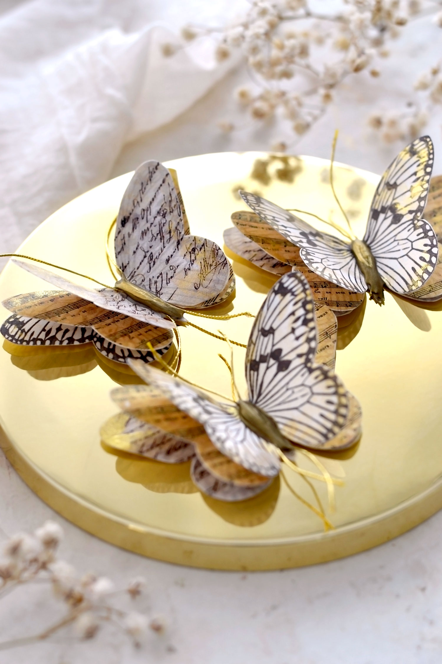 paper butterflies on gold tray