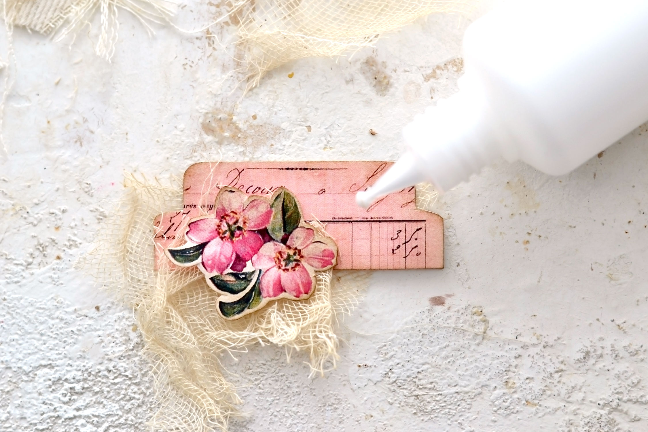gluing a tab with gauze and flowers