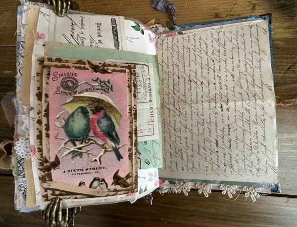 Journal spread with bird postcard