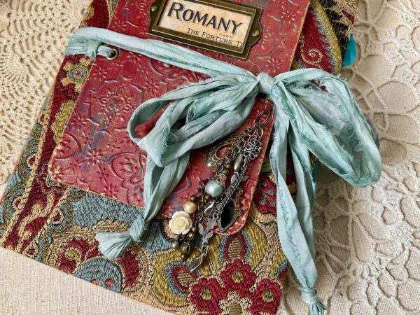 Close up of journal cover with ribbon and charms