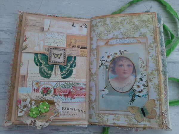Journal spread with cluster of lace, fabric and paper flowers