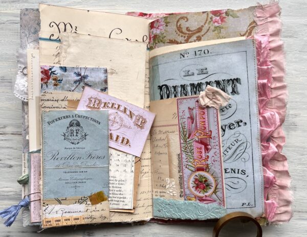 Journal spread with pink and blue ephemera