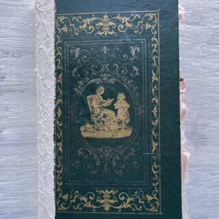 Journal with green cover and gold silhouette of woman and child