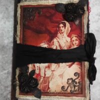 Red and black journal cover with black ribbon