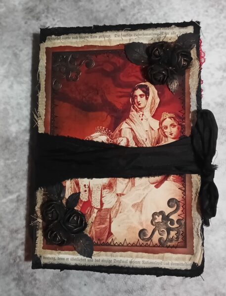 Red and black journal cover with black ribbon