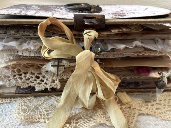 Side view of journal pages with cream ribbon