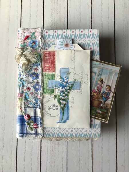 Junk journal with blue cross on cover