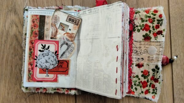 Junk journal spread with flower tags and red stitching