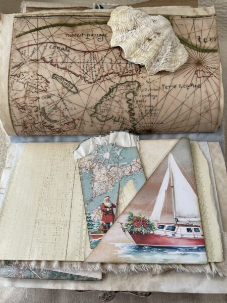 Junk journal spread with yacht tuck spot and Santa tag