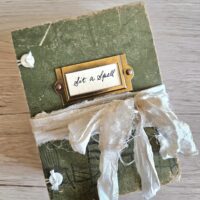 Green junk journal cover with cream ribbon