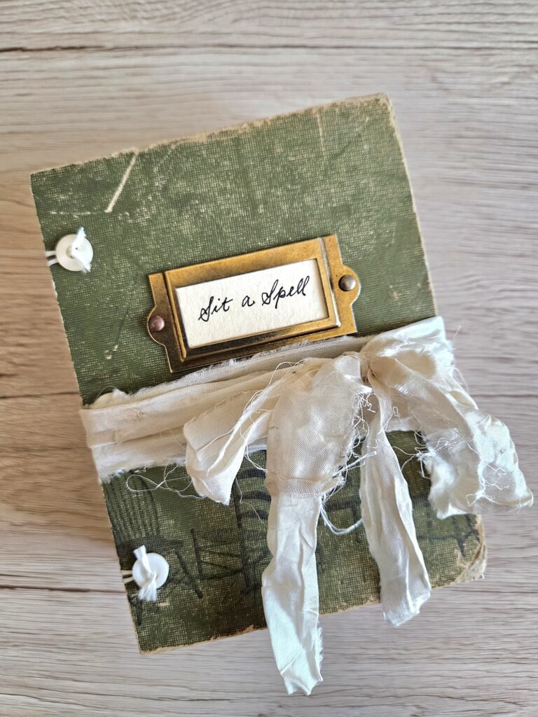 Green junk journal cover with cream ribbon