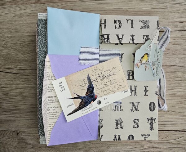 Journal spread with alphabet print and swallow bird