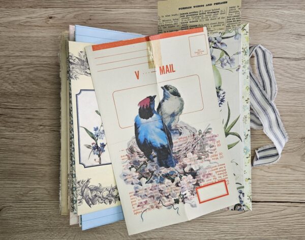 Journal spread with bird image on an envelope