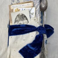 Junk journal cover with blue band at tea spoon attached