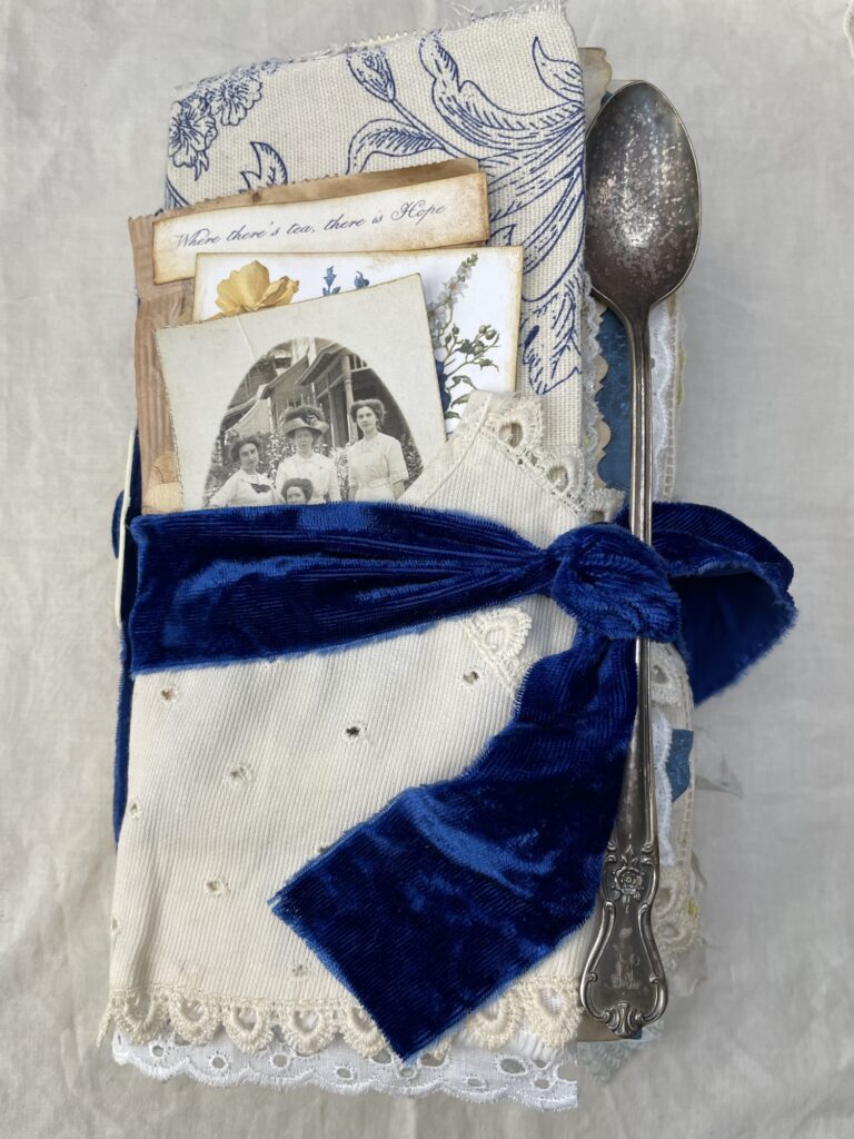 Junk journal cover with blue band at tea spoon attached