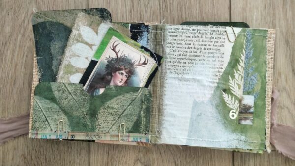 Journal spread with pocket made of green leaves and fairy card