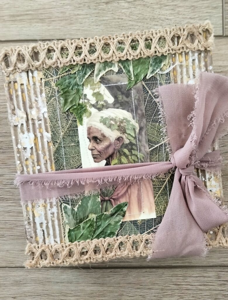Journal cover with woman's face, leaves and pink ribbon