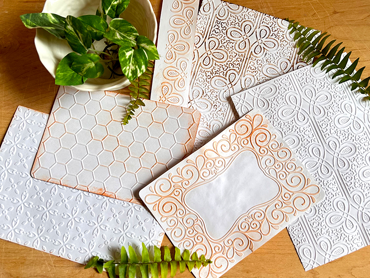 Distressed ink use to enhance embossed design