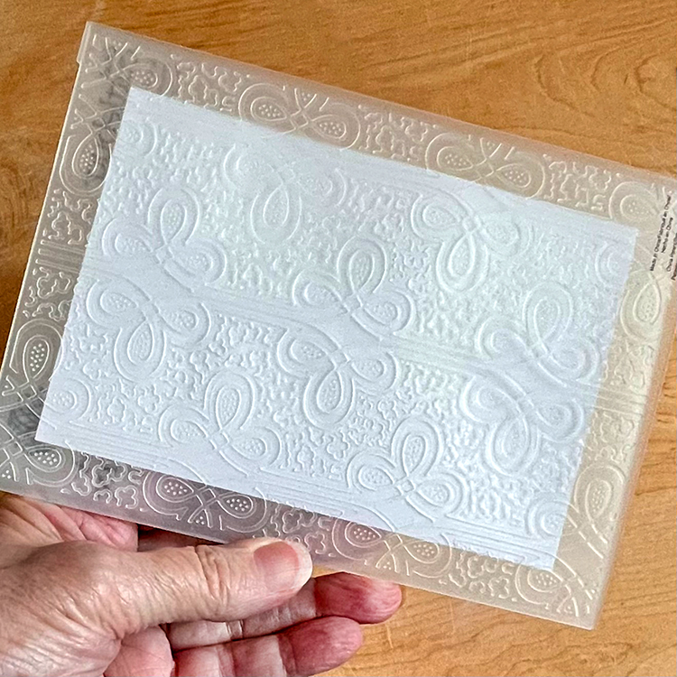 Card placed in embossing folder