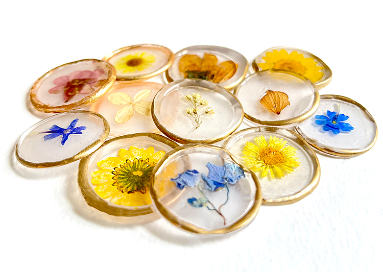 Clear was seals with dried flowers in a pile