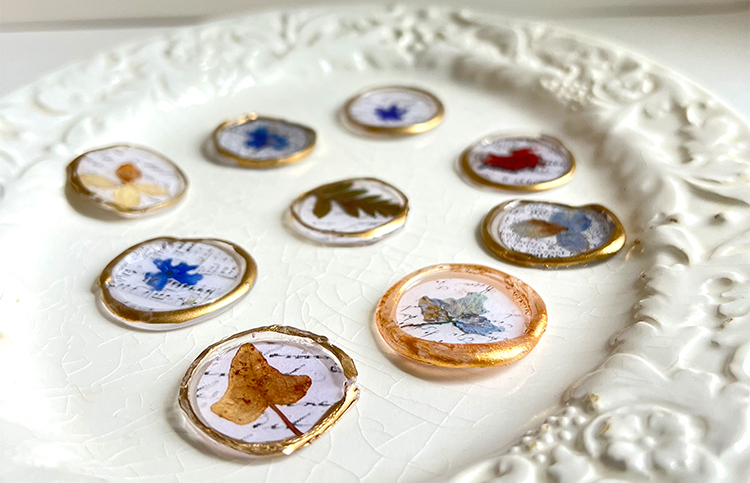 paper wax seals with dried flowers on plate