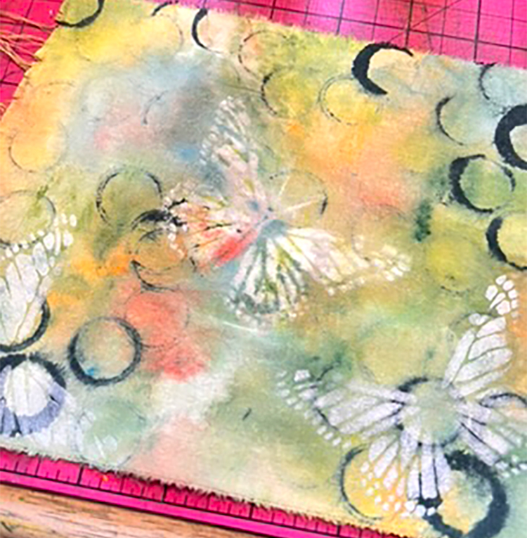 Paint layered over glue stick resist butterfly stencil