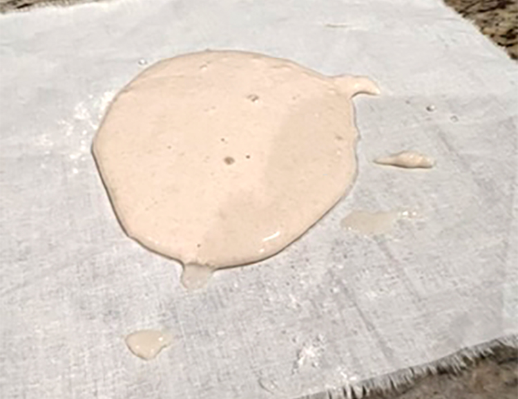Puddle of flour paste on cloth