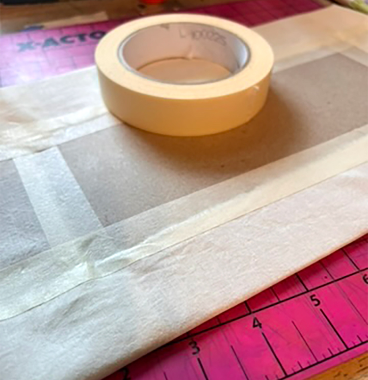 Fabric taped to cereal box for batik