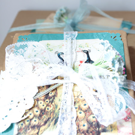 book bundles with lace and peacocks