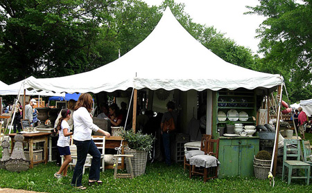 people shopping in tent at antiques market