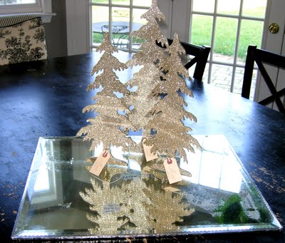 Christmas glitter trees on top of mirror on table